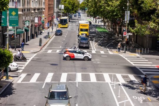 Cruise self-driving taxi in the centre of an intersection in San Francisco after driving through a red light.
