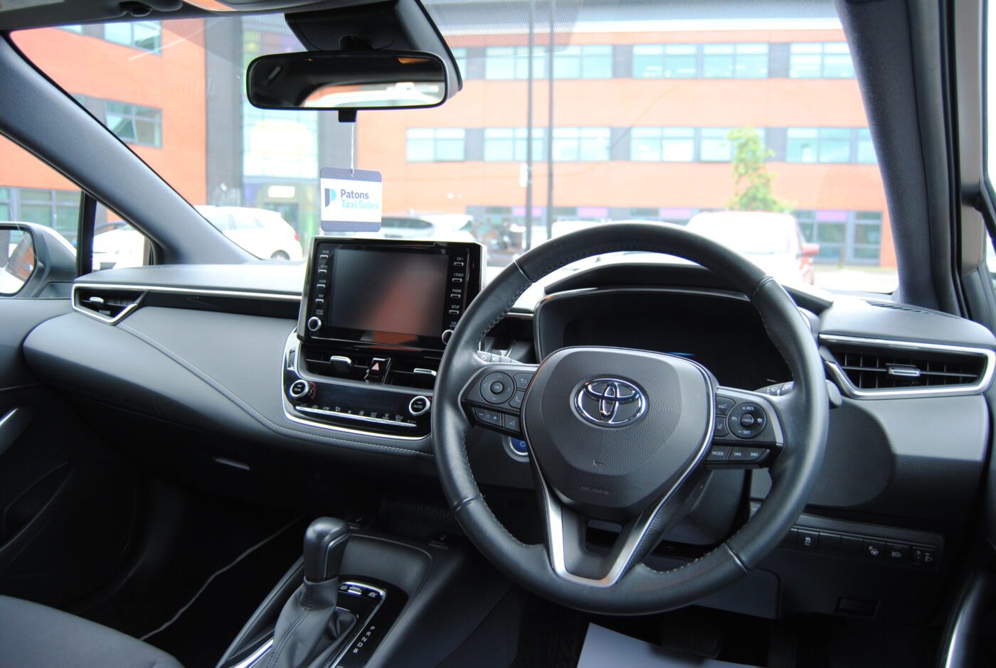 Dashboard, steering wheel and satnav in a Toyota Corolla