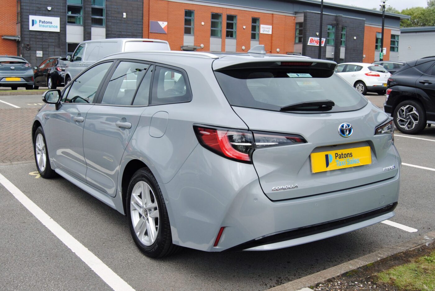 Back left side view of a grey Toyota Corolla