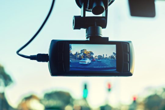 Dashboard camera in action installed on taxi windscreen